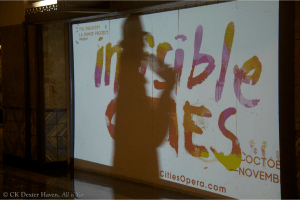 Invisible Cities - projection in Union Station as someone walks by (photo by CK Dexter Haven)